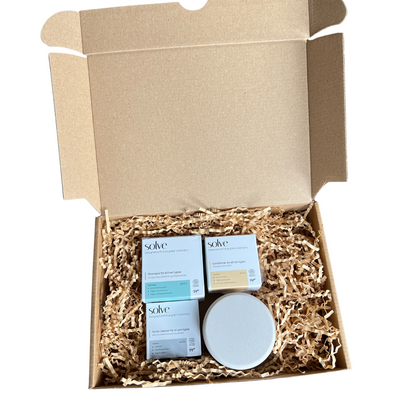 cosmetics bundle box showcasing solid care bundle including sustainable conditioner, shampoo and facial cleanser