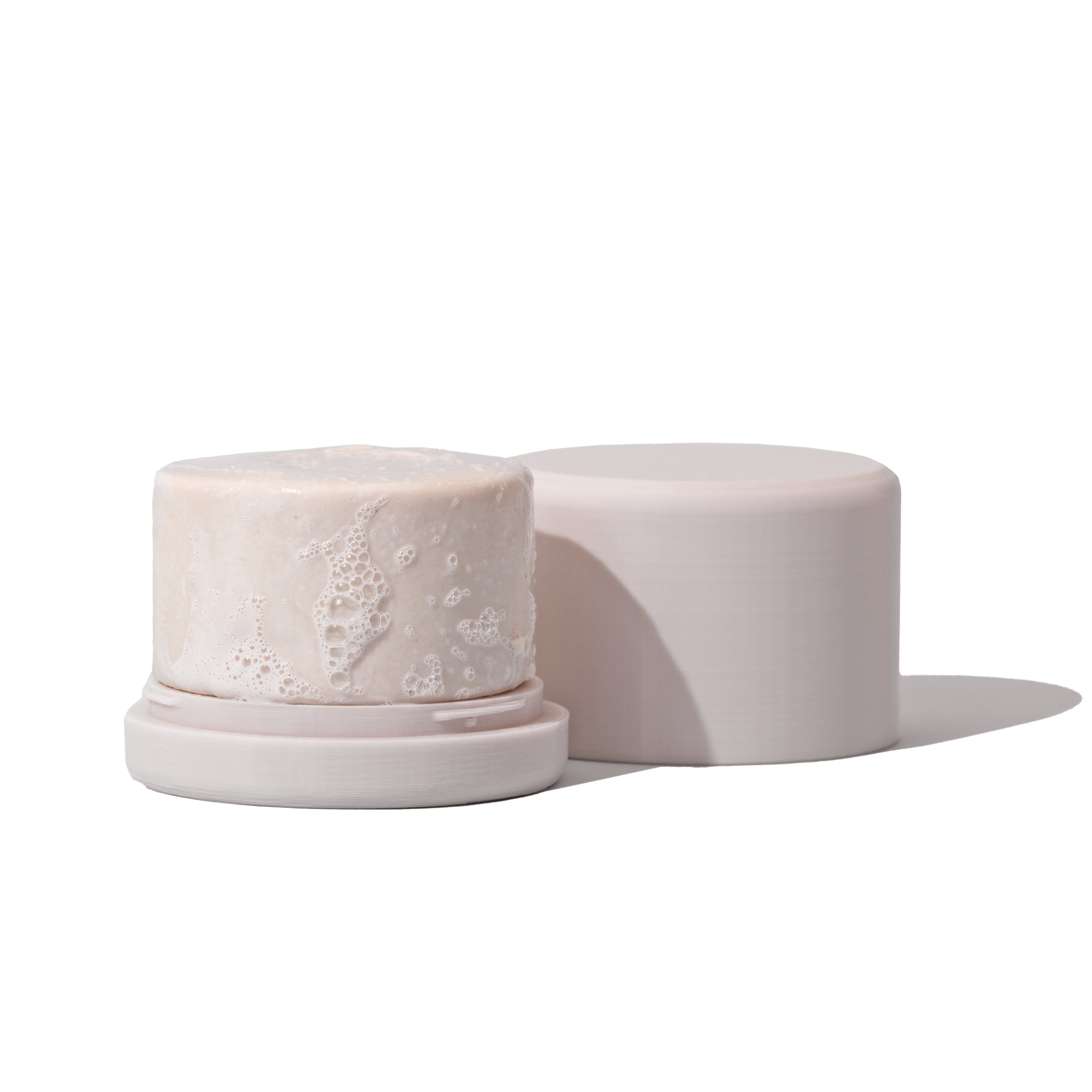 Eco-friendly shampoo bar holder with a solid shampoo, preventing sogginess and maximizing usage for all hair types.